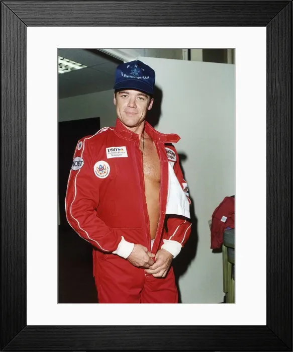 Framed Print : Stefan Dennis Actor undressing motor racing overall Framed Print : Stefan Dennis Actor undressing motor racing overall