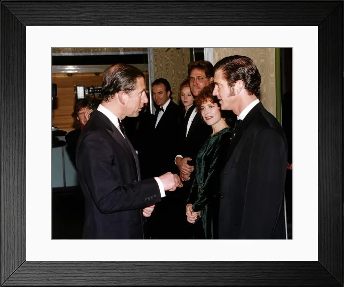 Framed Print : Mel Gibson actor speaking to Prince Charles at the premiere of his film Framed Print : Mel Gibson actor speaking to Prince Charles at the premiere of his film