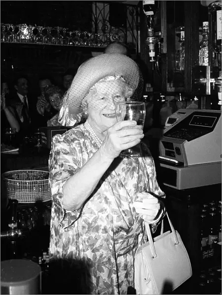 Queen Mother drinks a pint of beer in a pub in Stepney
