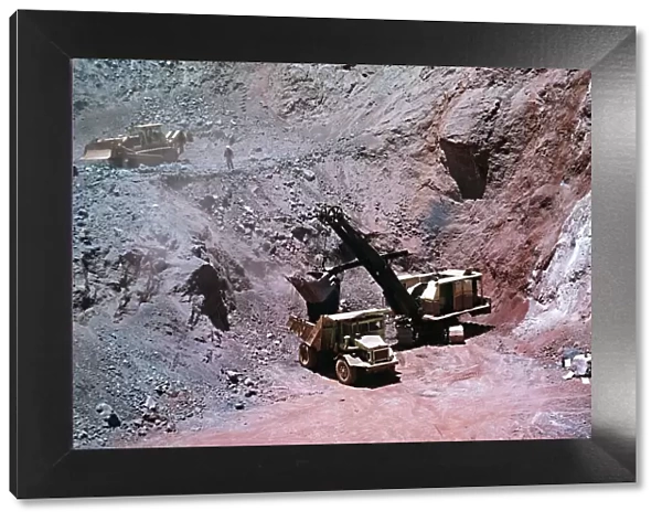 Excavator loads Iron-ore into lorry at Mine, Cassinga Angola