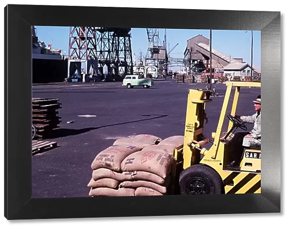 Forklift truck loading fishmeal onto a ship at Docks Walvis Bay