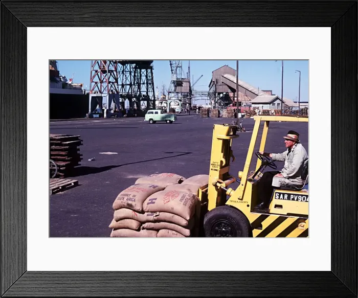 Framed Print : Forklift truck loading fishmeal onto a ship at Docks Walvis Bay