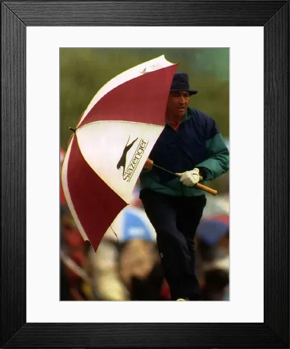Framed Print : Seve Ballesteros holding a golf umbrella at his side whilst walking to the next hole Framed Print : Seve Ballesteros holding a golf umbrella at his side whilst walking to the next hole
