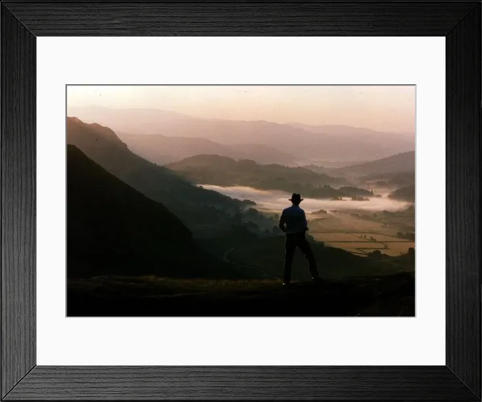 Framed Print : Dawn rises over the Lake District as a walker travels along a lakeland pass