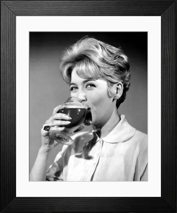 Framed Print : Woman drinking from cocktail glass November 1961 Framed Print : Woman drinking from cocktail glass November 1961