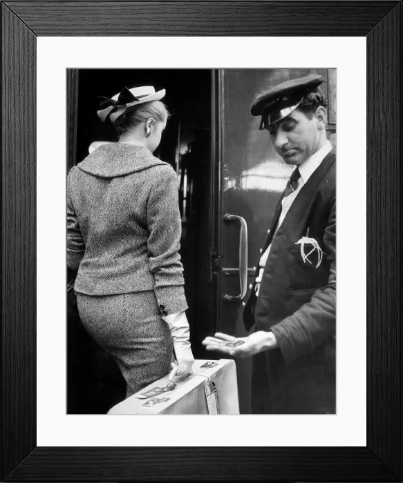 Framed Print : A Railway porter look down at the meager tip given to him by a woman passenger after Framed Print : A Railway porter look down at the meager tip given to him by a woman passenger after