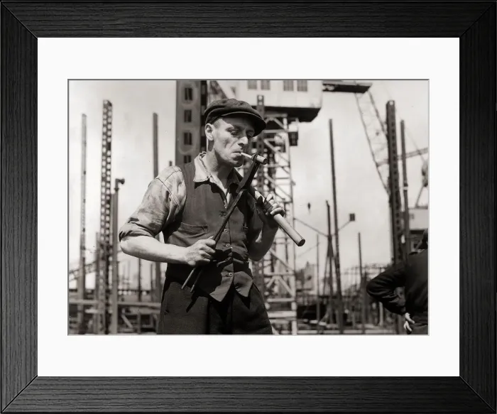 Framed Print : George Howard hand rivetter lights a cigarette from a white hot rivet Framed Print : George Howard hand rivetter lights a cigarette from a white hot rivet