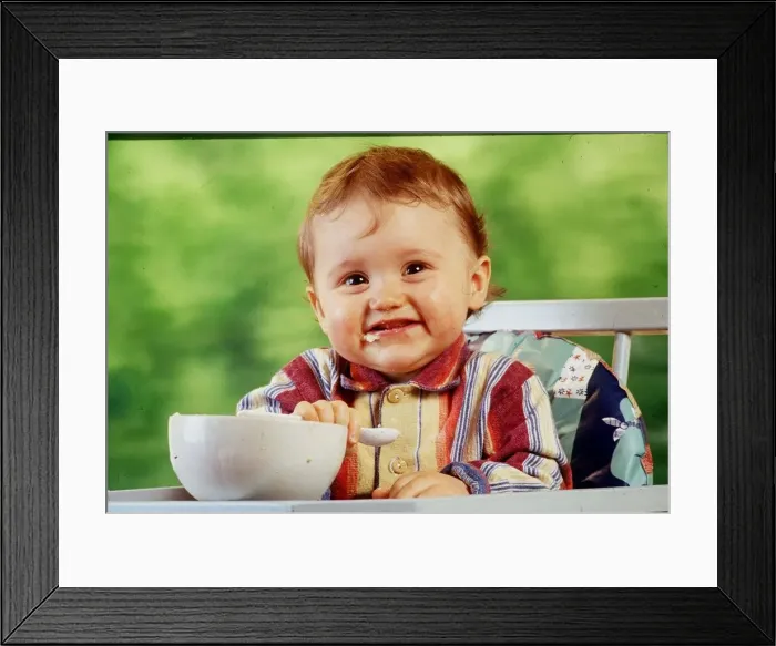 Framed Print : A child is pictured eating April 1999 Framed Print : A child is pictured eating April 1999