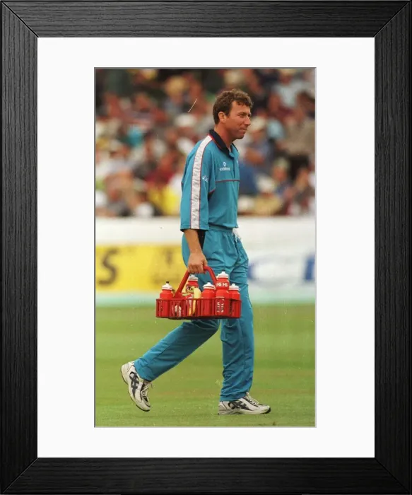 Framed Print : Mike Atherton of England and Lancashire August 1998 carries the drinks holder Framed Print : Mike Atherton of England and Lancashire August 1998 carries the drinks holder