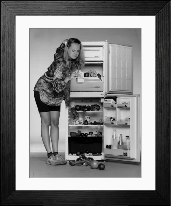 Framed Print : A woman checks the sell by date on the milk in her fridge 1990 Framed Print : A woman checks the sell by date on the milk in her fridge 1990