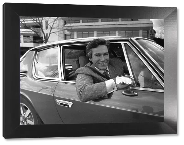 Simon Dutton Actor leans out of the window of an Aston Martin DBS March 1989