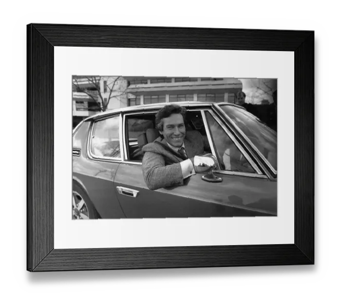 Framed Print : Simon Dutton Actor leans out of the window of an Aston Martin DBS March 1989