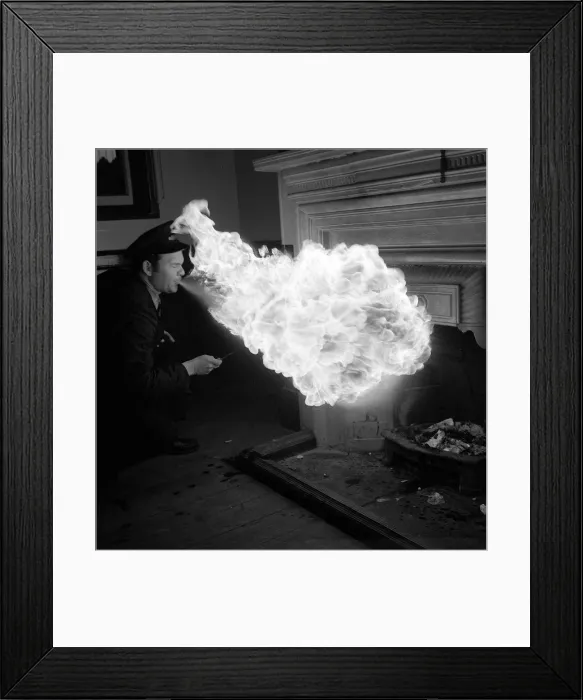 Framed Print : Danny Almond a porter at the Woodgate Park station lights the waiting room grate in his