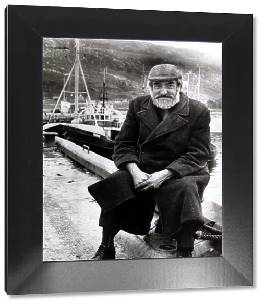 Old Man sitting at harbour circa 1950