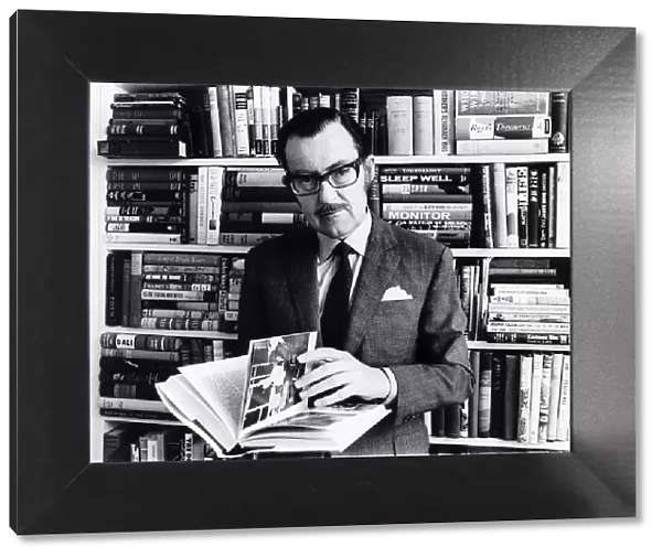 Alan Whicker TV presenter in his library in his flat May 1968 in Regents Park