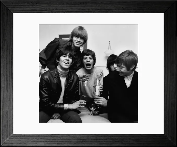 Framed Print : Rolling Stones celebrate in their Manchester hotel after hearing news that their latest