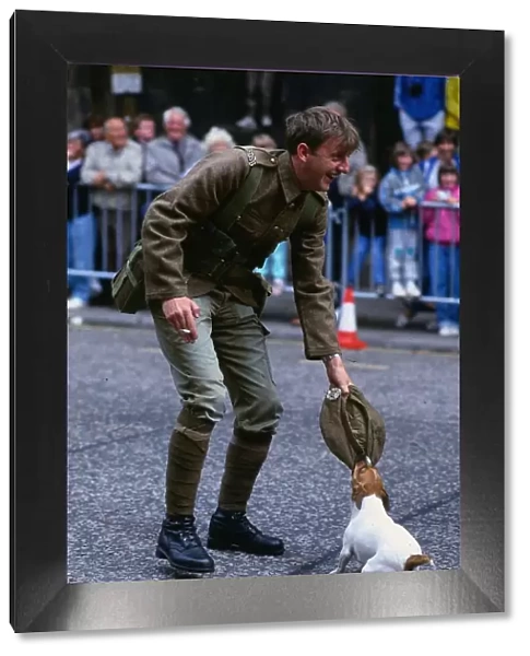 Edinburgh Festival August 1989 Dog chewing soldiers cap holding cigarette