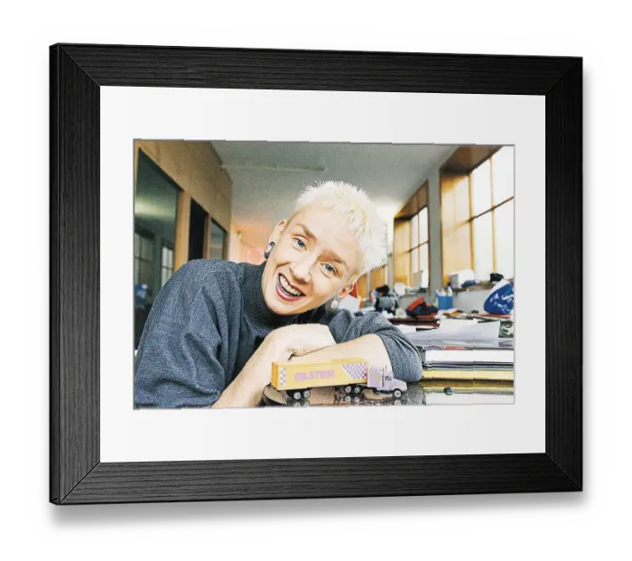 Framed Print : Muriel Gray leaning on desk with toy American truck TV Presenter A©mirrorpix