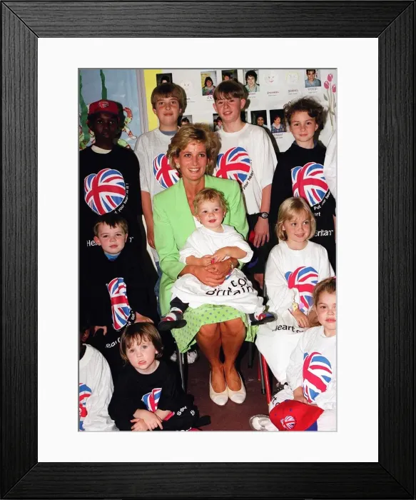 Framed Print : Princess Diana Princess of Wales with James Perry sitting on her knee during a visit to a Framed Print : Princess Diana Princess of Wales with James Perry sitting on her knee during a visit to a