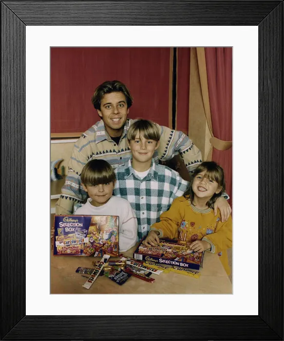 Framed Print : Pat Sharp childrens TV Presenter with children testing chocolate christmas selection Framed Print : Pat Sharp childrens TV Presenter with children testing chocolate christmas selection