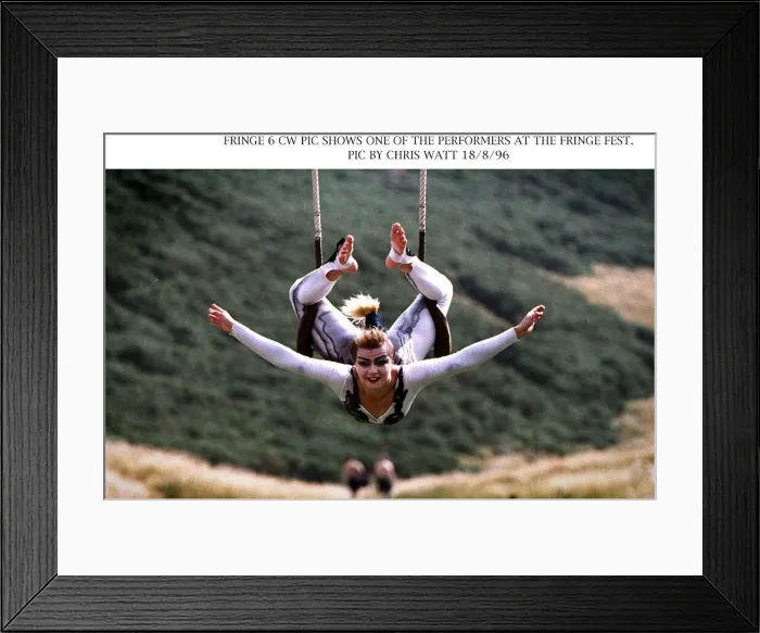 Framed Print : Edinburgh Fringe Festival performer acrobat hanging onto swing with legs arms Framed Print : Edinburgh Fringe Festival performer acrobat hanging onto swing with legs arms