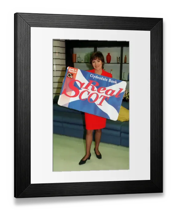 Framed Print : Lorraine Kelly TV Presenter with the Clydesdale Bank Real Scot Card wearing red suit Framed Print : Lorraine Kelly TV Presenter with the Clydesdale Bank Real Scot Card wearing red suit