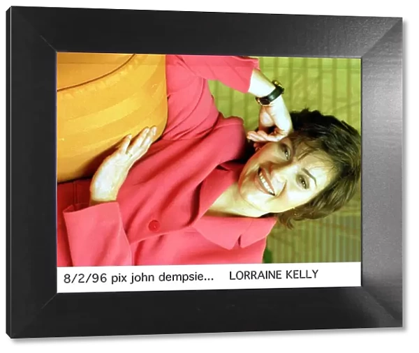 Lorraine Kelly TV Presenter wearing pink jacket and black strap watch A©mirrorpix