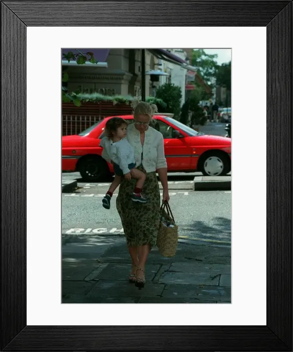 Framed Print : Paula Yates TV Presenter September 1998 Leaving her home in Notting Hill holding Framed Print : Paula Yates TV Presenter September 1998 Leaving her home in Notting Hill holding