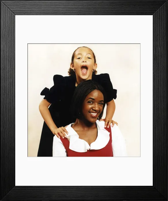 Framed Print : Diane Louise Jordan with young girl her niece Justine in black dress A©mirrorpix