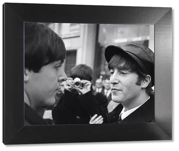 John Lennon and Paul McCartney having their picture taken by George Harrison