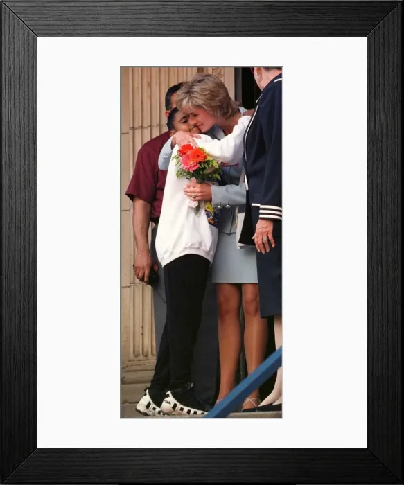 Framed Print : Diana, Princess of Wales, hugs a young girl who gave her flowers as she leaves Cook Framed Print : Diana, Princess of Wales, hugs a young girl who gave her flowers as she leaves Cook