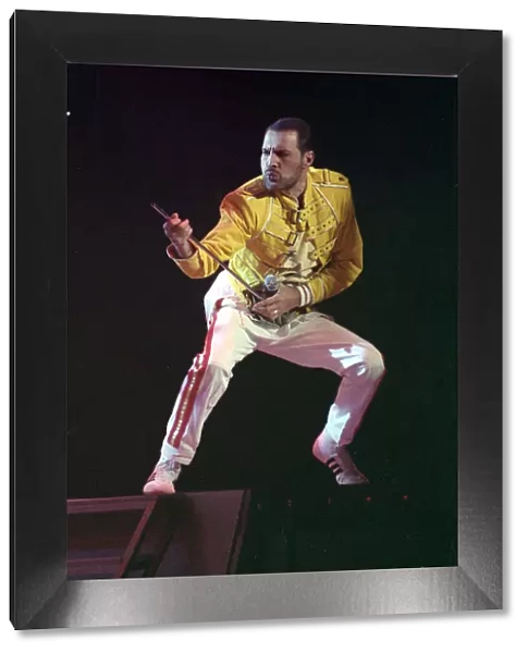 Freddie Mercury of Queen on stage, performing an air guitar. November 1989