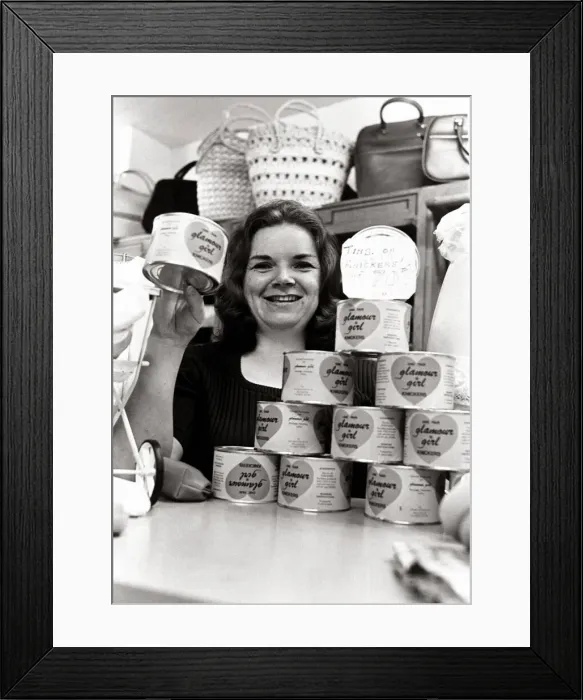 Framed Print : Salesgirl Delia Dixon showing off some of the tinned knickers she has on sale in her shop Framed Print : Salesgirl Delia Dixon showing off some of the tinned knickers she has on sale in her shop