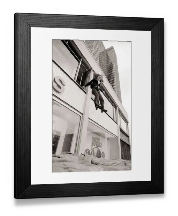 Framed Print : With a smile on her face stunt girl Sue Crosland plunges 30ft from a window in the Thames