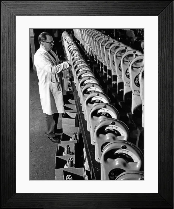 Framed Print : Parking Meters being checked using a stopwatch in the factory prior to dispatch all Framed Print : Parking Meters being checked using a stopwatch in the factory prior to dispatch all