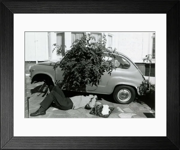 Framed Print : Geoff Poupard tinkers underneath his greenhouse car Framed Print : Geoff Poupard tinkers underneath his greenhouse car