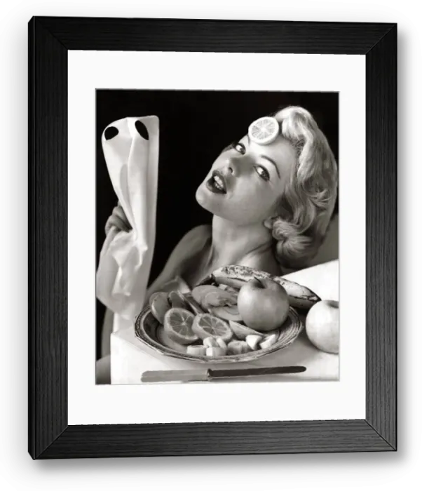 Framed Print : A woman relaxing with a slice of orange on her head and a bowl of fruit beside her 1957 Framed Print : A woman relaxing with a slice of orange on her head and a bowl of fruit beside her 1957