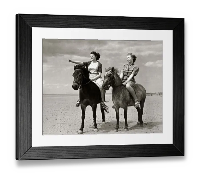 Framed Print : Two women out riding their horses on the beach at Hunstanton in Norfolk at the start of Framed Print : Two women out riding their horses on the beach at Hunstanton in Norfolk at the start of