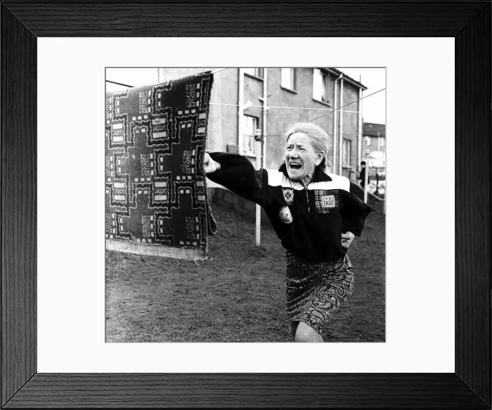 Framed Print : Annie Sweeney (a grand mother) is using a piece of carpet as she practices Karate for her