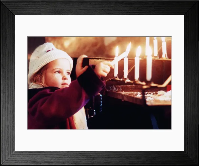 Framed Print : A young girl Katie Hughes Boyton lights a candle for peace at Westminster Cathedral