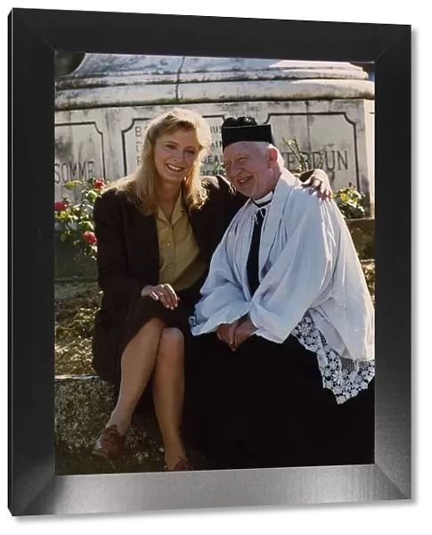 Kate Buffery sitting on wall with Priest January 1989 Dbase