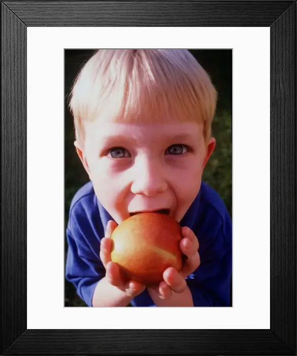 Framed Print : A child is pictured eating in Eating feature April 1999 Framed Print : A child is pictured eating in Eating feature April 1999