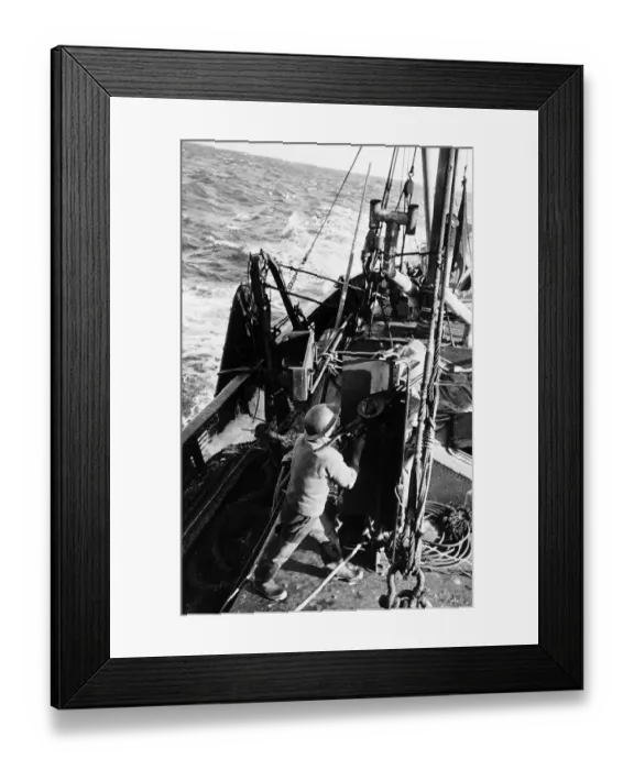 Framed Print : Fisherman aboard British trawler fires an anti-aircraft gun at an enemy plane during WW2 Framed Print : Fisherman aboard British trawler fires an anti-aircraft gun at an enemy plane during WW2