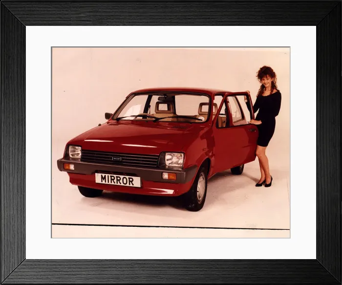 Framed Print : RED METRO MODEL STANDING NEXT TO CAR COMPETITION PRIZE MINI METRO Framed Print : RED METRO MODEL STANDING NEXT TO CAR COMPETITION PRIZE MINI METRO