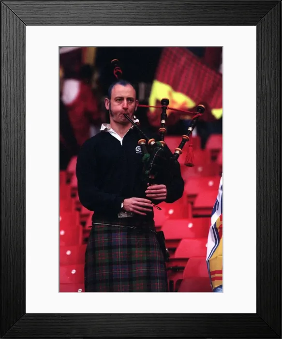 Framed Print : A Scottish fan plays the bagpipes at the end of the Scotland v England match which Framed Print : A Scottish fan plays the bagpipes at the end of the Scotland v England match which