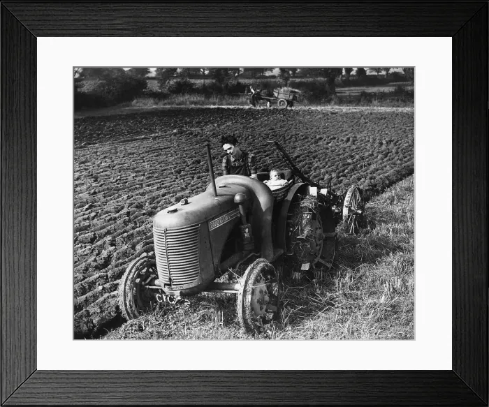 Framed Print : MRP Wyatt runs a tractor on a Glamorgan farm near Cardiff Her six month old child Betty