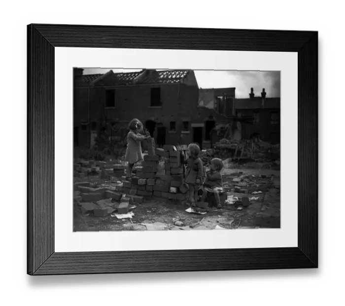 Framed Print : Children playing on bomb site after a bombing raid in London during WW2
