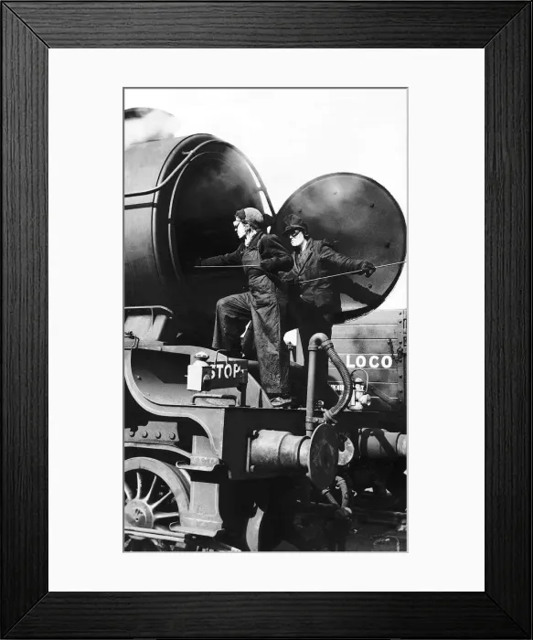 Framed Print : Women railway workers clean out a steam engine boiler during WW2. 1942