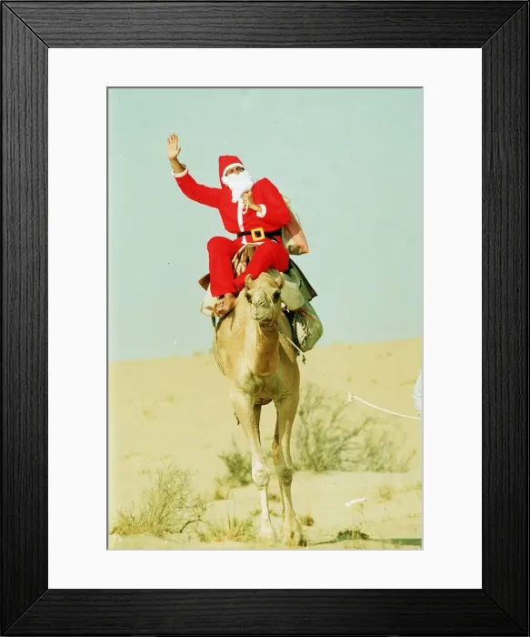 Framed Print : Santa Claus riding a camel holding sack