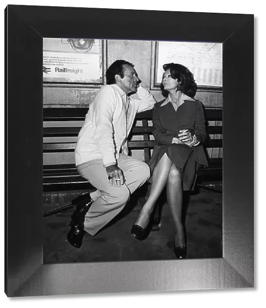 Richard Burton with Sophia Loren on a bench at a train station filming the play brief
